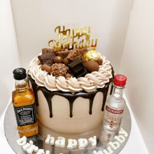 Custom made birthday cake with mini whisky bottles and chocolate topping